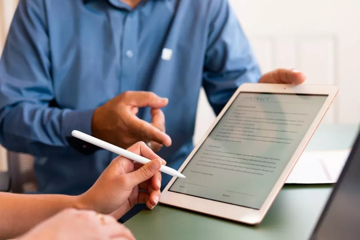 signing a tablet with a solar salesperson